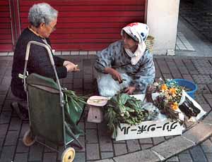 Marchande sur le trottoir - Copyright F. Jeorge